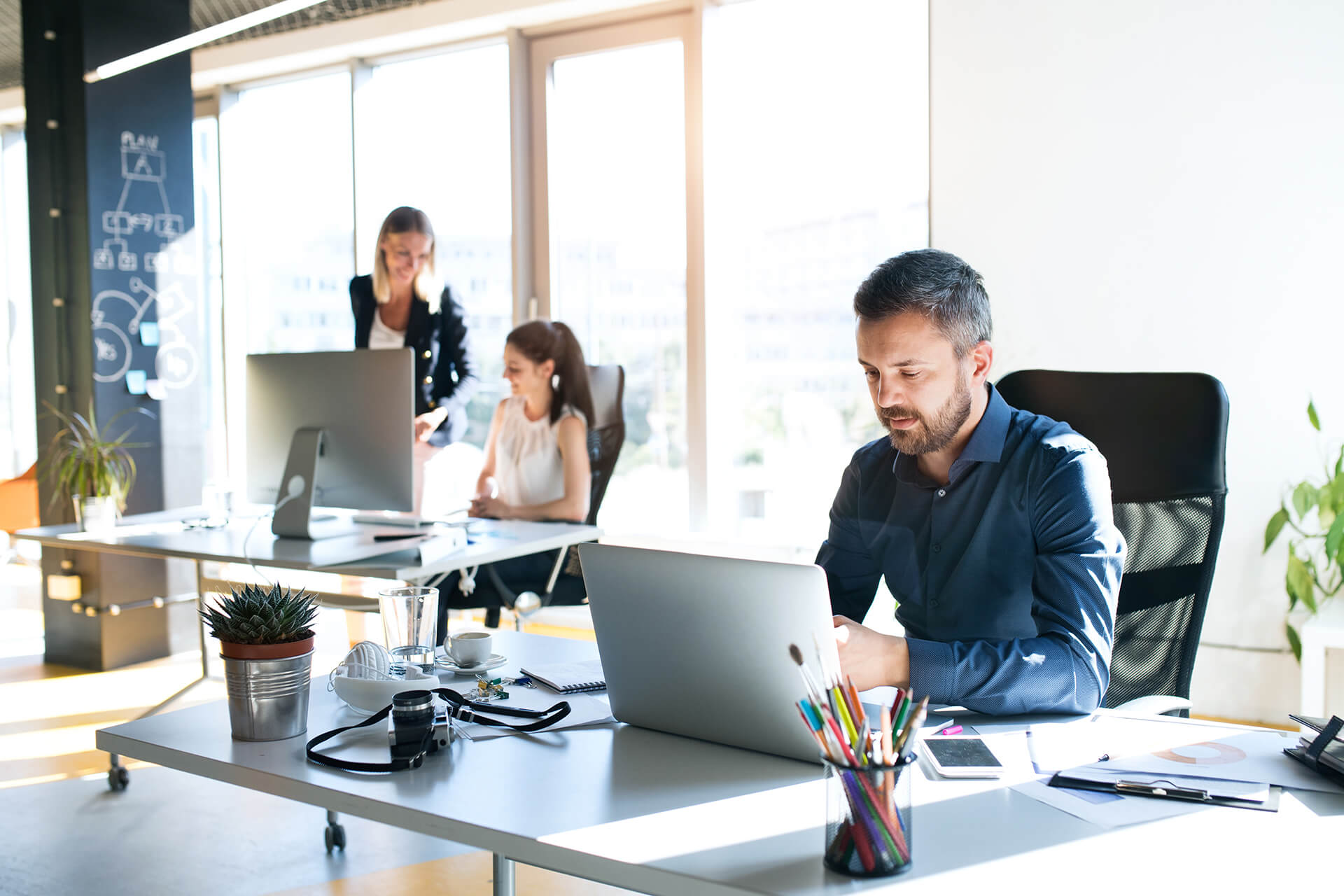 Three People Working In The Office